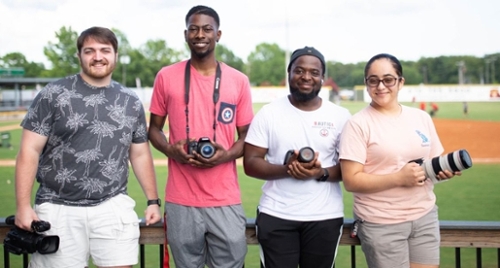 Recent MGA media & communication majors during their photography/videography internships with the Macon Bacon baseball team.